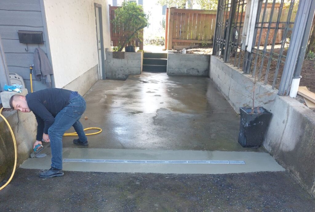 Finishing the concrete around a California drain in Saanichton