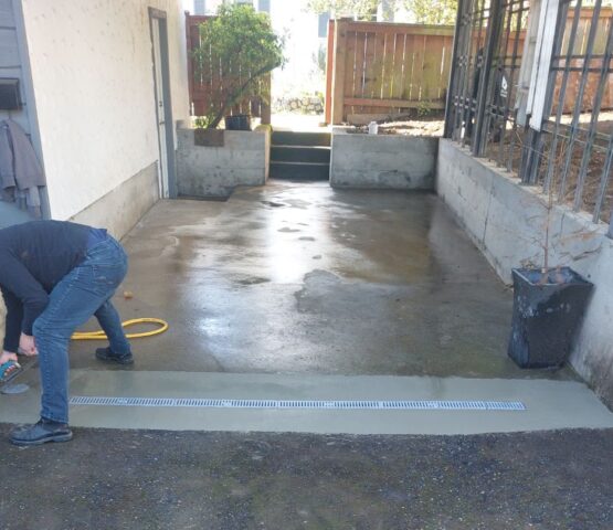 Finishing the concrete around a California drain in Saanichton